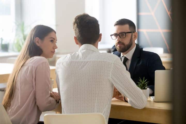 California Insurance Broker Bond (Personal Lines) $10,000 - Broker listening to clients during office meeting or consultations.