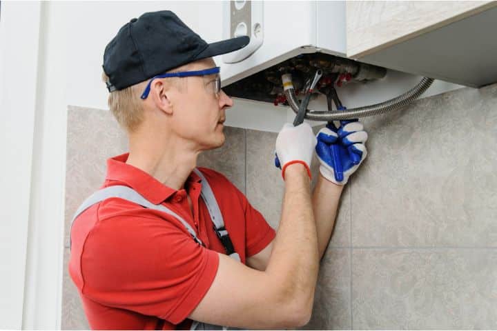 Dothan, AL-Gas System, Piping or Appliance Installation Bond ($5,000) - Worker installs or attaches pipe gas boiler.