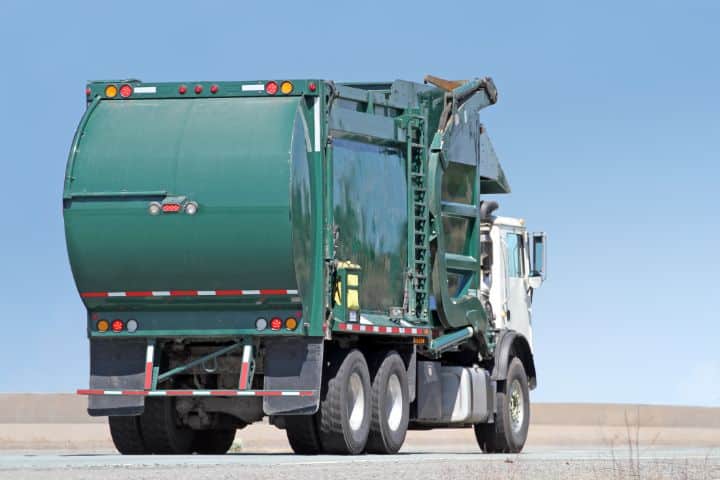 Daphne, AL-Solid Waste Hauling Bond - A waste management, Industrial waste truck traveling highway.
