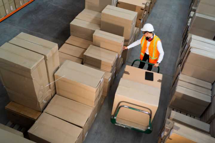 California Third Party Logistics Provider Bond - A man with his uniform, a hardhat working hard a logistics warehouse.