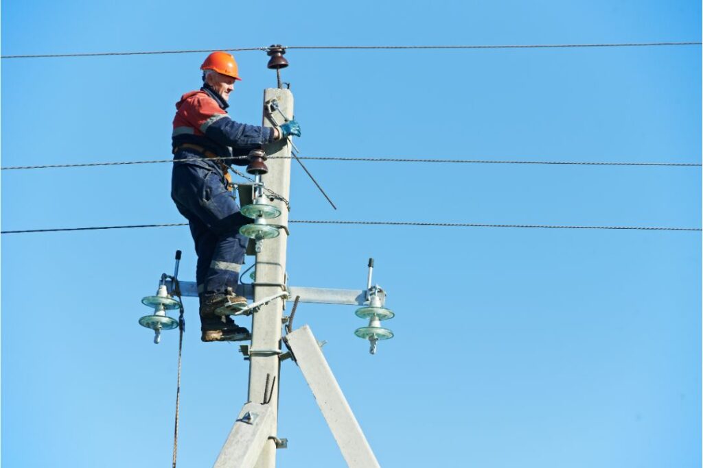 Southern California Edison Utility Deposit Bond - Power electrician lineman at work on pole lines for electricity need.