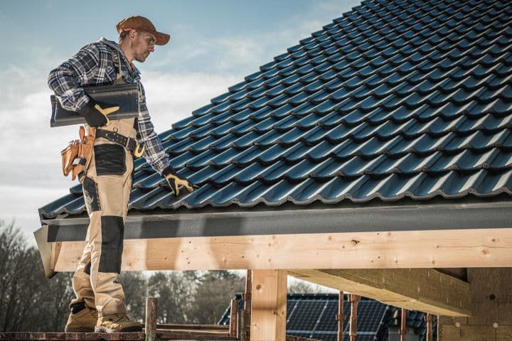 Alaska Residential Contractor Bond ($20,000) - Carpenter installing roof shingles.