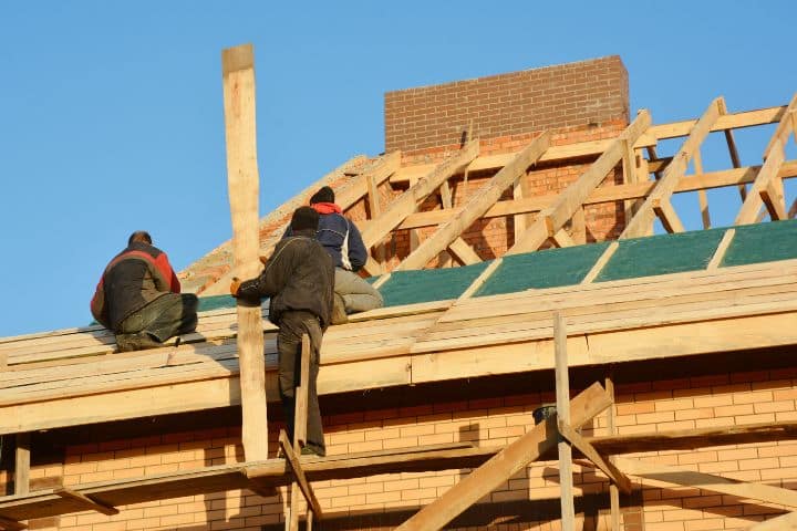 Arizona Taxpayer Bond for Contractor - Roofing contractors installing house framework.