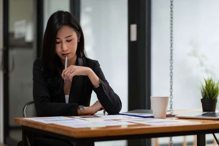California MEMO Financial Services, Inc dba MEMO MEMO Money Order Bond - Portrait of an attractive Asian businesswoman working for marketing and financial plan.