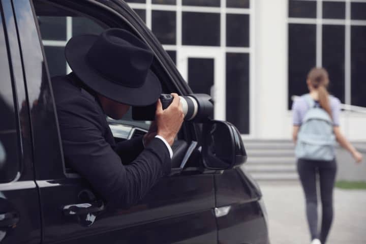 Montgomery, AL-Private Investigator Bond ($25,000)-A private detective with a camera spying from a car.