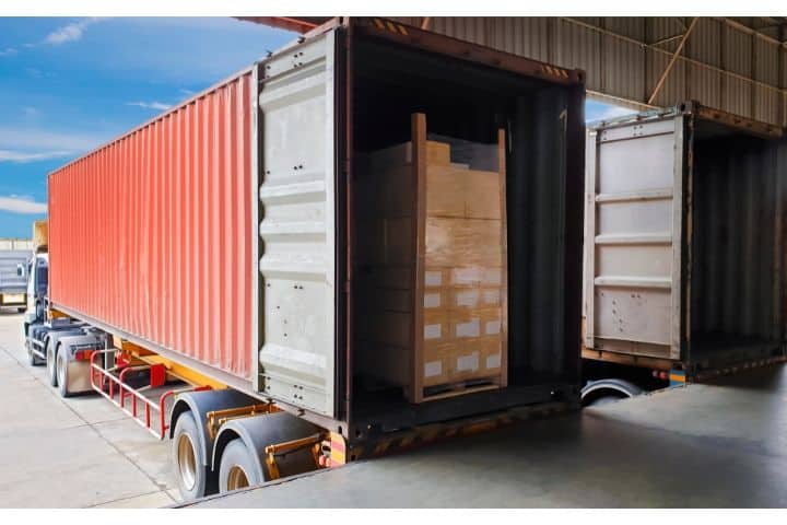 Alabama Transportation Broker Bond ($10,000) - A truck trailer docking load cargo at the warehouse. Freight industry warehouse logistics.