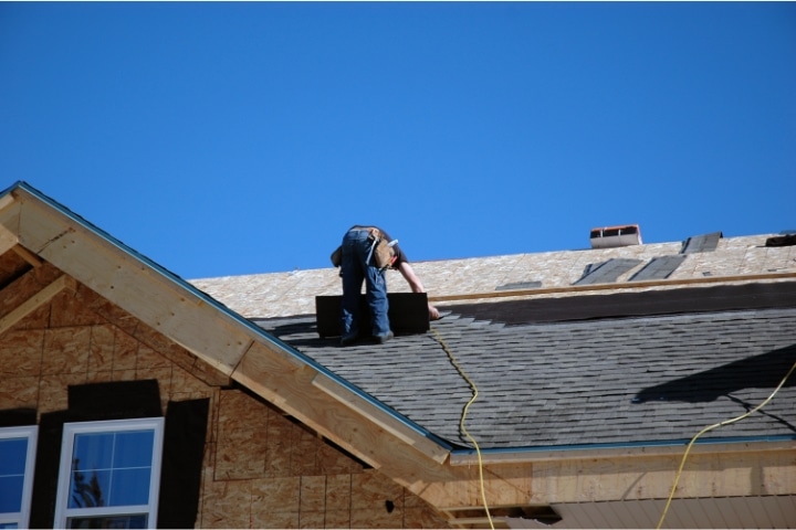 Haines City, FL - Roofer ($5,000) Bond - A roofer on top of the roof.