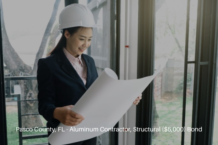 Pasco County, FL - Aluminum Contractor, Structural ($5,000) Bond - Architect reviewing the blueprint.