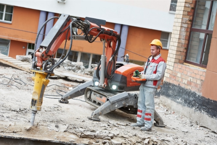 Palm Beach County, FL - Demolition Contractor ($10,000) Bond - Builder worker operating demolition machine.