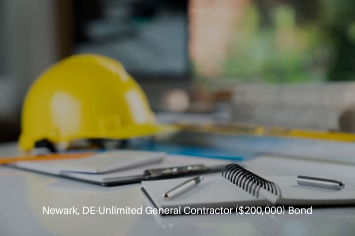 Newark, DE-Unlimited General Contractor ($200,000) Bond - Contractor concept. Yellow hard hat, libella and plans on a the whole table.