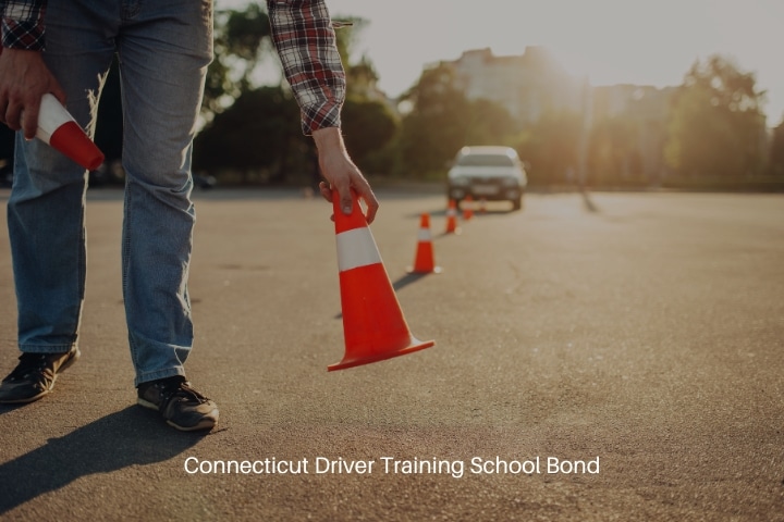 Connecticut Driver Training School Bond - The instructor sets the cone for the examination. Driving school concept.