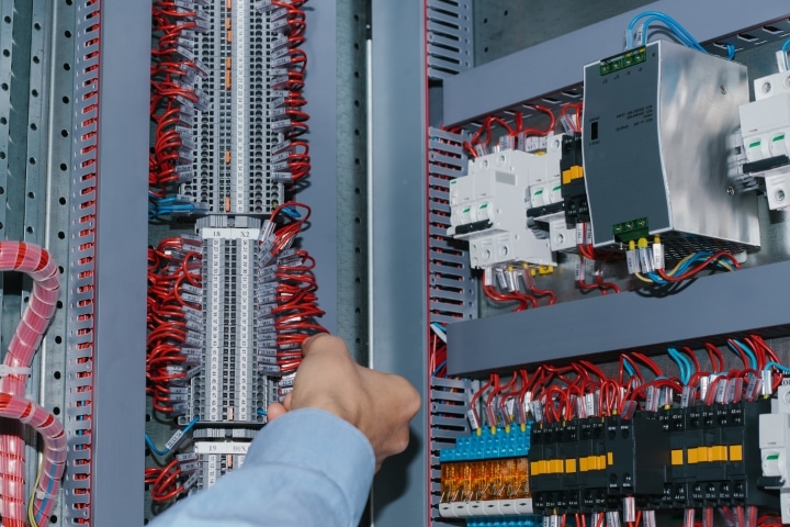 Osceola County, FL - Low Voltage Electrical ($5,000) Bond - Electrician specialist checking low-voltage cabinet equipment.