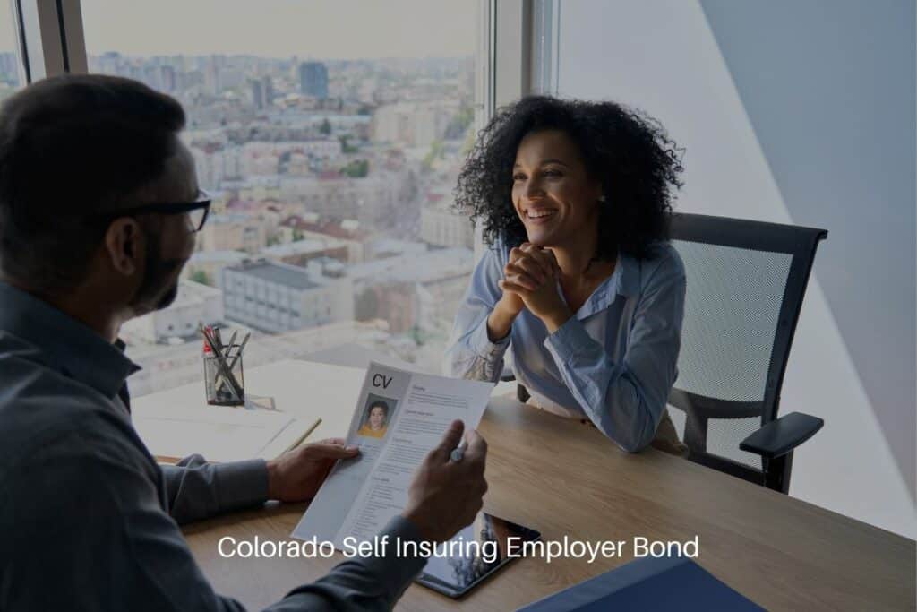 Colorado Self Insuring Employer Bond - Woman getting interviewed by her employer holding her paper CV.