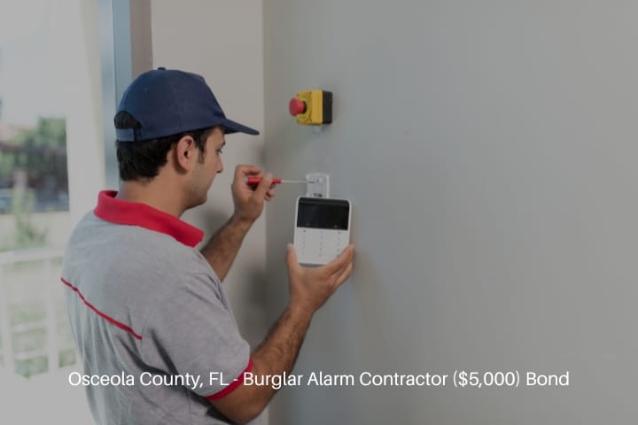 Osceola County, FL - Burglar Alarm Contractor ($5,000) Bond - Man installing security alarm system.