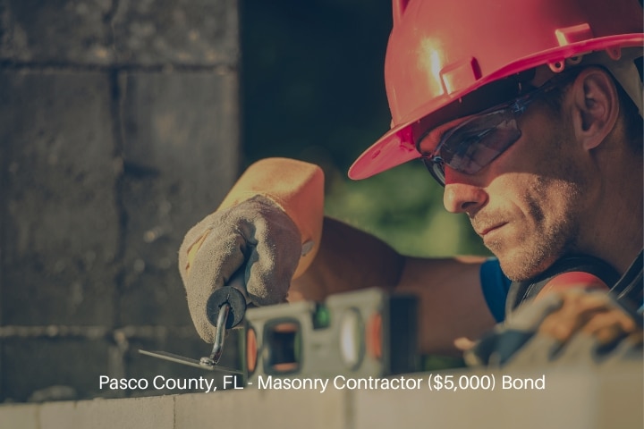 Pasco County, FL - Masonry Contractor ($5,000) Bond - Masonry worker in hard hat.