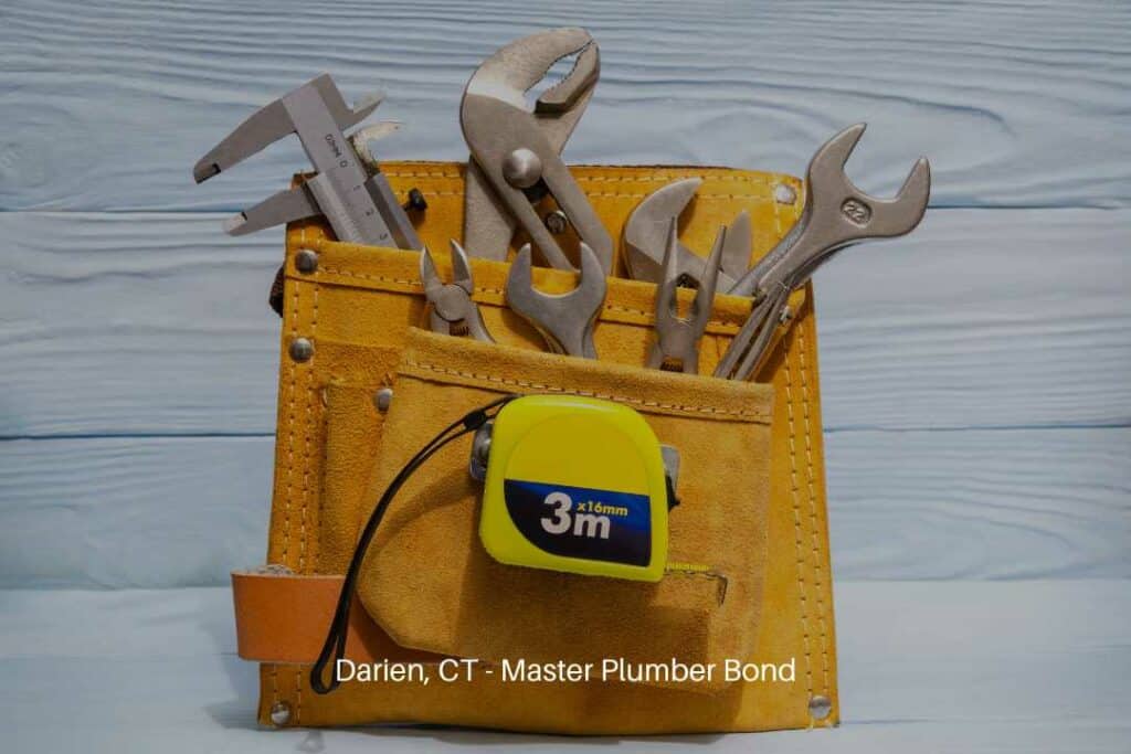 Darien, CT - Master Plumber Bond - Set of tools in a suede bag for master plumbers on blue wooden boards.