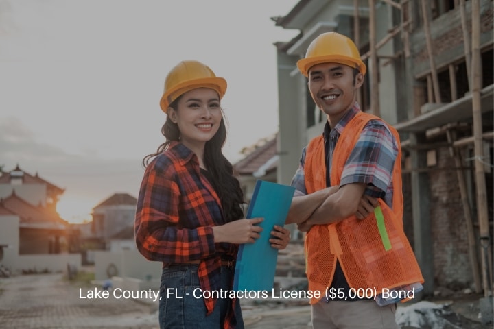 Lake County, FL - Contractors License ($5,000) Bond - Two asian contractors stood wearing safety helmets and vests.