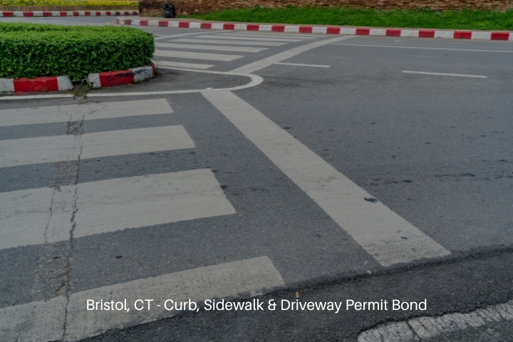 Bristol, CT - Curb, Sidewalk & Driveway Permit Bond - White crosswalk on asphalt road with red and white curb.