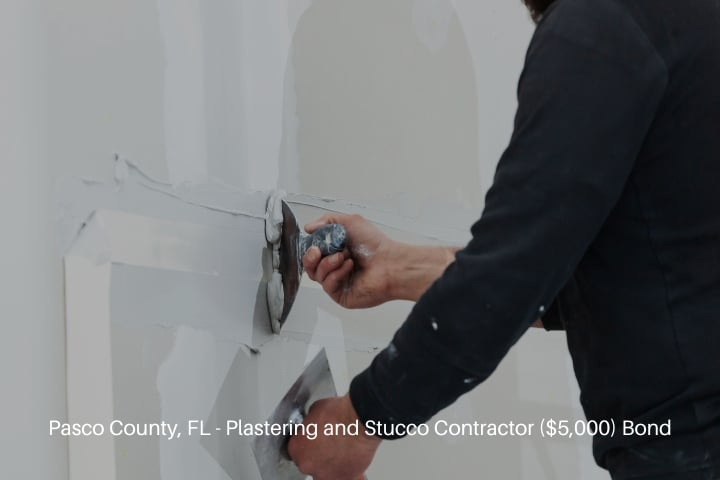 Pasco County, FL - Plastering and Stucco Contractor ($5,000) Bond - Worker plastering gypsum board walls.