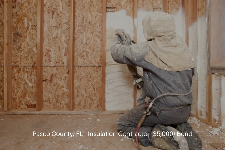 Pasco County, FL - Insulation Contractor ($5,000) Bond - Worker spraying expandable foam insulation between wall studs.
