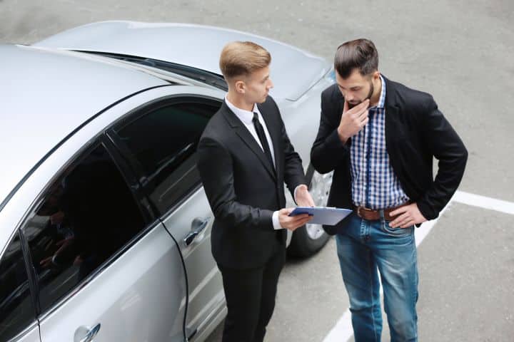 California Foreign Vehicle Ownership Bond - Young man with car dealer outdoors.