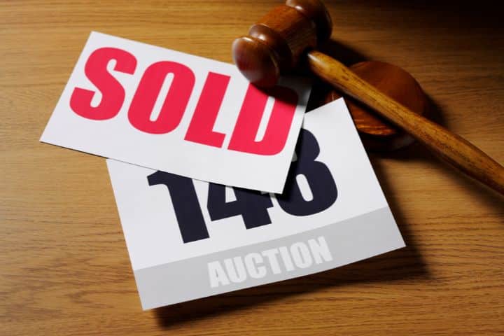 California Auctioneer ($20,000) Bond - Auction paddle and gavel with a sold and auction number in a paper.