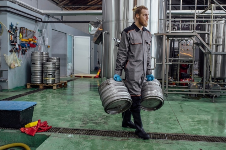 Florida Spirits Manufacturer Bond - Craft beer manufacturing. Brewery worker carrying beer barrels.