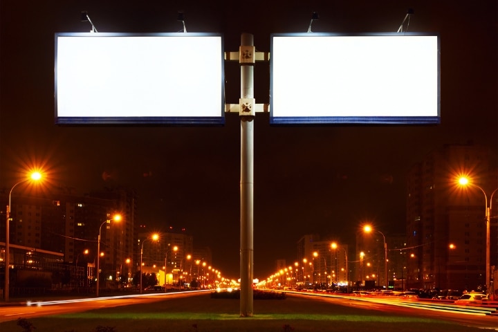 Pasco County, FL - Sign Contractor, Non-Electrical ($5,000) Bond - Double big white billboard on lighting street at night.