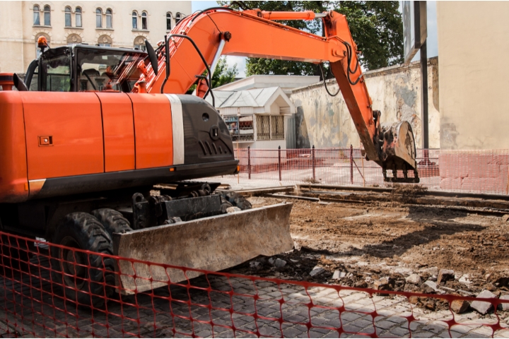 Okeechobee, FL - Street Opening Bond - Excavator on the street digging.