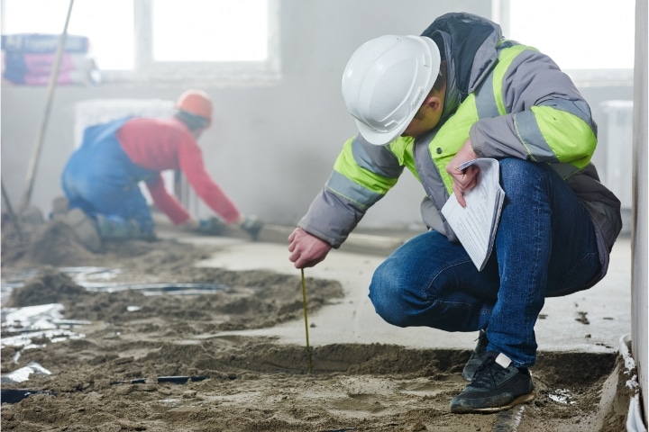 Manatee, FL - Cement Contractor Bond - Foreman builder inspecting concrete.