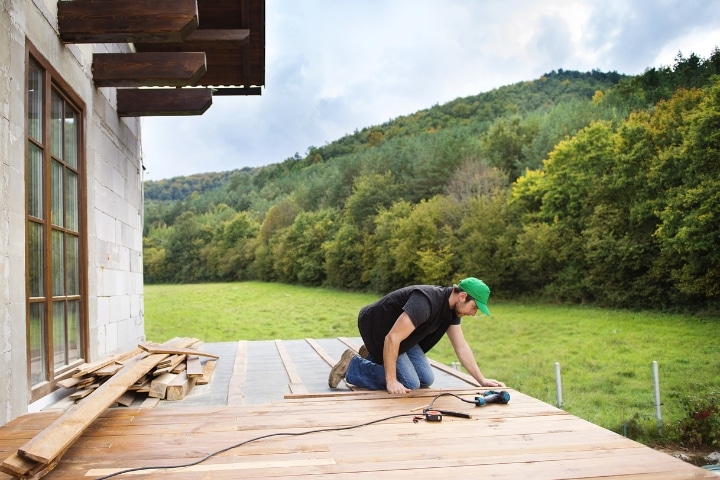 FL - Lumber Liquidators Inc Installation Provider Bond - Handyman installing wooden flooring.