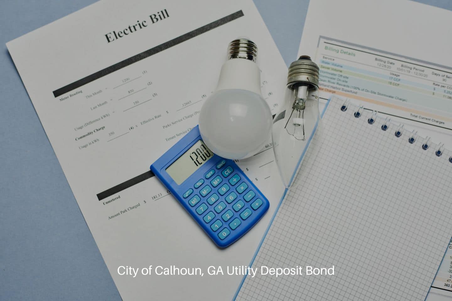 City of Calhoun, GA Utility Deposit Bond - Monthly utility bill, Bulb, and a calculator and note.