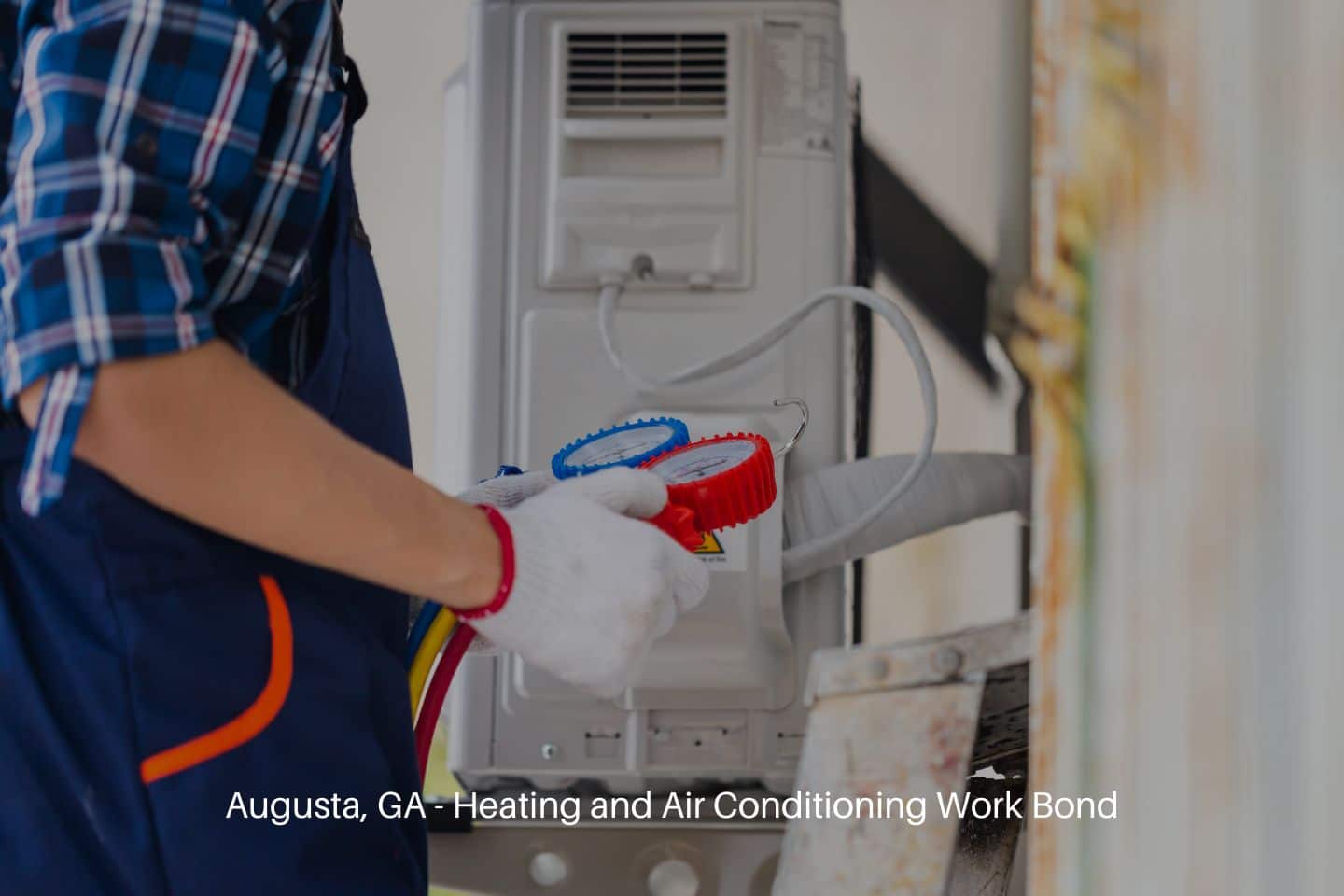 Augusta, GA - Heating and Air Conditioning Work Bond - Air conditioning repair. Repairman fixing air conditioning system.