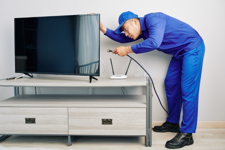 Polk County, FL - Cable TV Franchise ($5,000) Bond - Repairman in blue uniform installing cable tv.