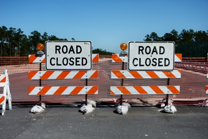 Jacksonville, FL - Barricade ($5,000) Bond - Road closed barricades sign in the middle of the street.