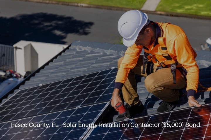 Pasco County, FL - Solar Energy Installation Contractor ($5,000) Bond - Solar panel technician with drill installing solar panels.