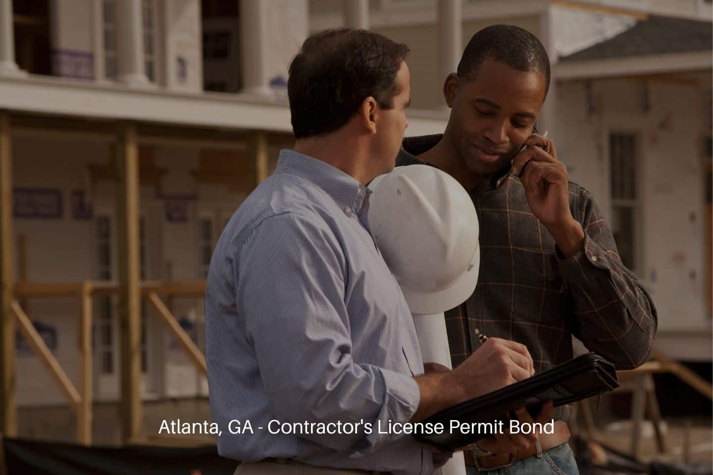 Atlanta, GA - Contractor's License Permit Bond - Two contractors looking over plan details.