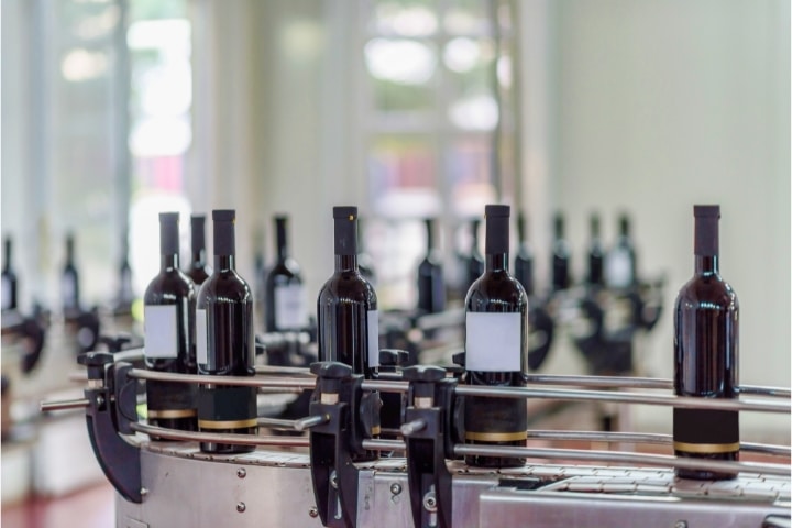 Florida Wine Manufacturer Bond - Wine bottling and sealing conveyor.