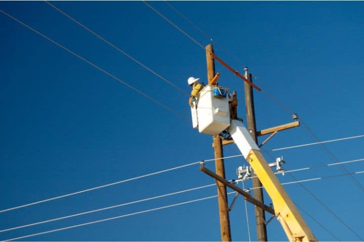 Arab Electric Cooperative Utility Deposit Bond (Alabama) - Electric utility lineman working with the help of a crane.