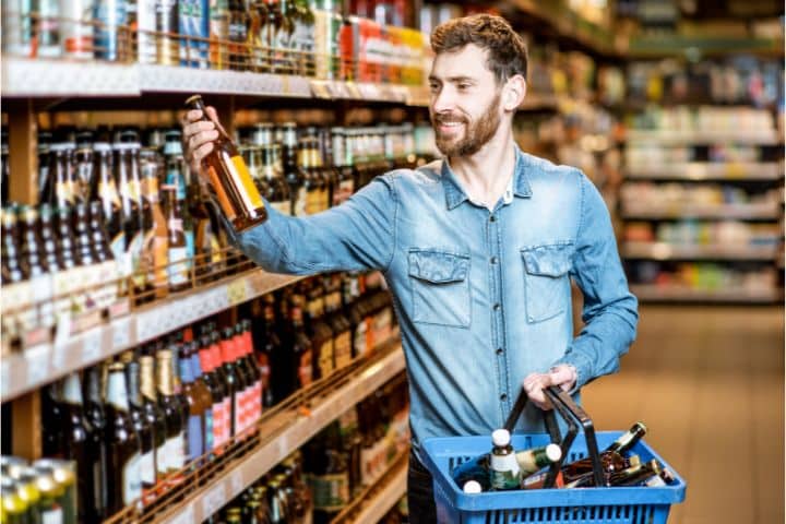 Good Hope, AL-Alcohol Tax or Fee Bond ($10,000) - A man buying a beer in the supermarket.