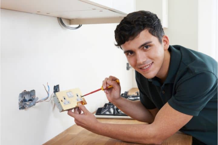 Fairfield, AL-Electrician Bond - A portrait of an electrician installing a socket in a new house.