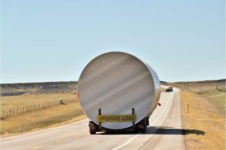 Arkansas Movement of Vehicles of Excess Size or Weight Bond - An oversized load truck along the road of nowhere.