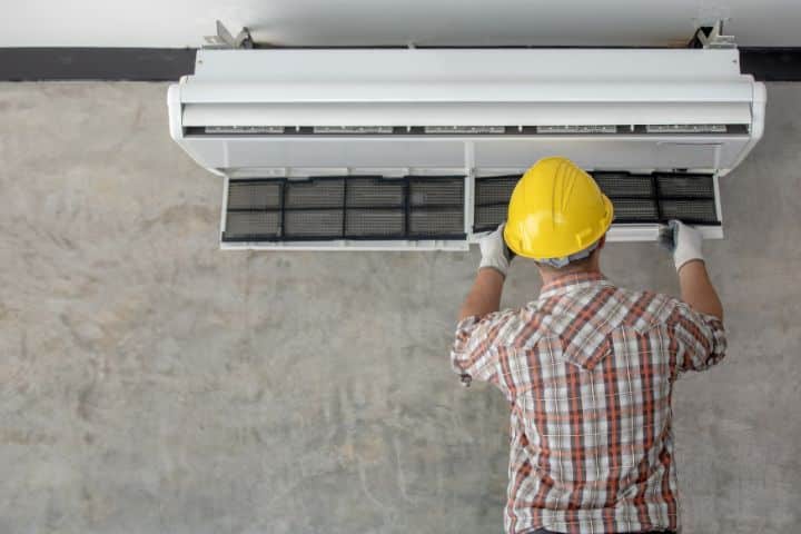 Arizona Contractor's License Bond - Air conditioning technician repairing the air conditioner.