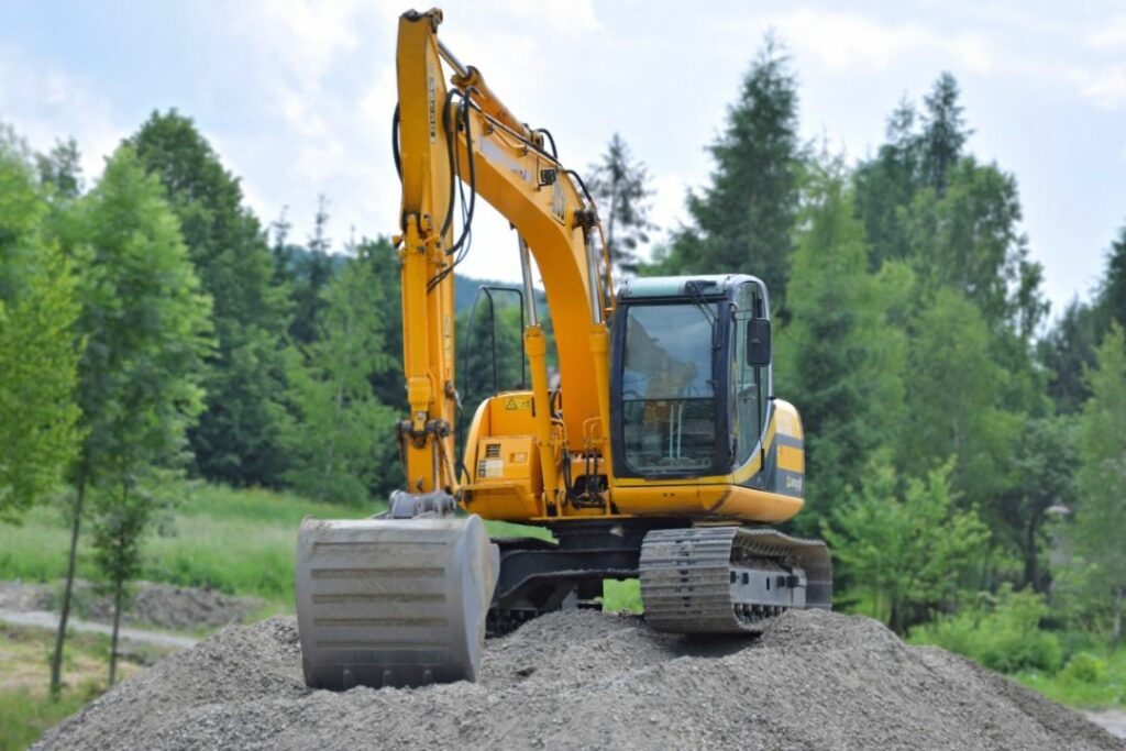 Plymouth, CT - Excavating ($5,000) Bond - A yellow excavator at the top of the soil the contractor excavates.