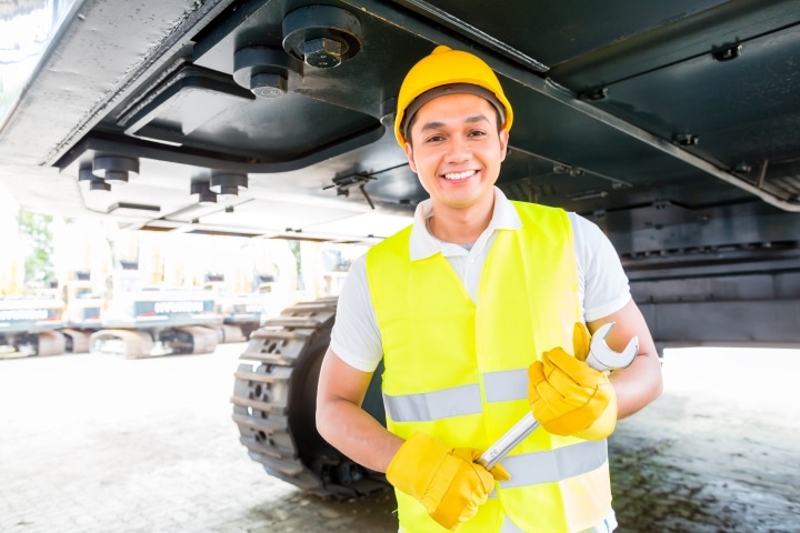 Connecticut Supplemental Special Surety - Asian mechanic repairing construction vehicle.
