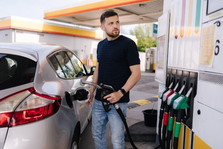 Connecticut Special Fuel Distributor Bond - Bearded man refueling car and looking at the price per liter.