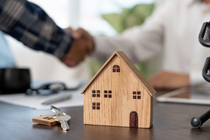 Connecticut Mortgage Broker Bond - Mortgage broker concept with key and house miniature.