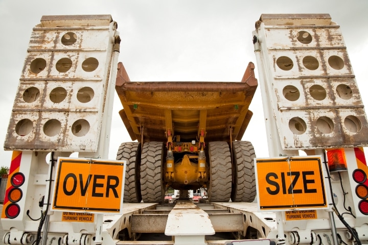 Florida Excess Size and Weight Bond - Over size mining dump truck on float trailer.