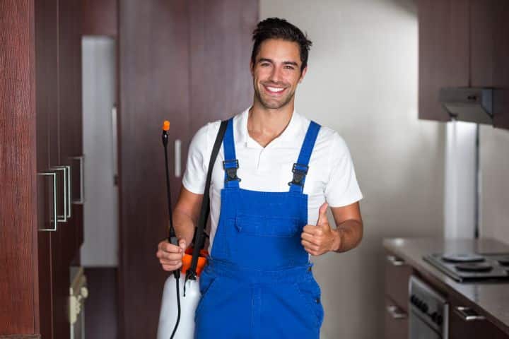 California Pest Control Business Licensees Bond - A man doing pest control in the kitchen.