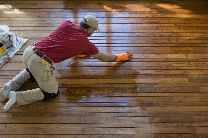 Pasco County, FL - Finish Carpentry Contractor ($5,000) Bond - Residential worker doing a refinish on the floor.